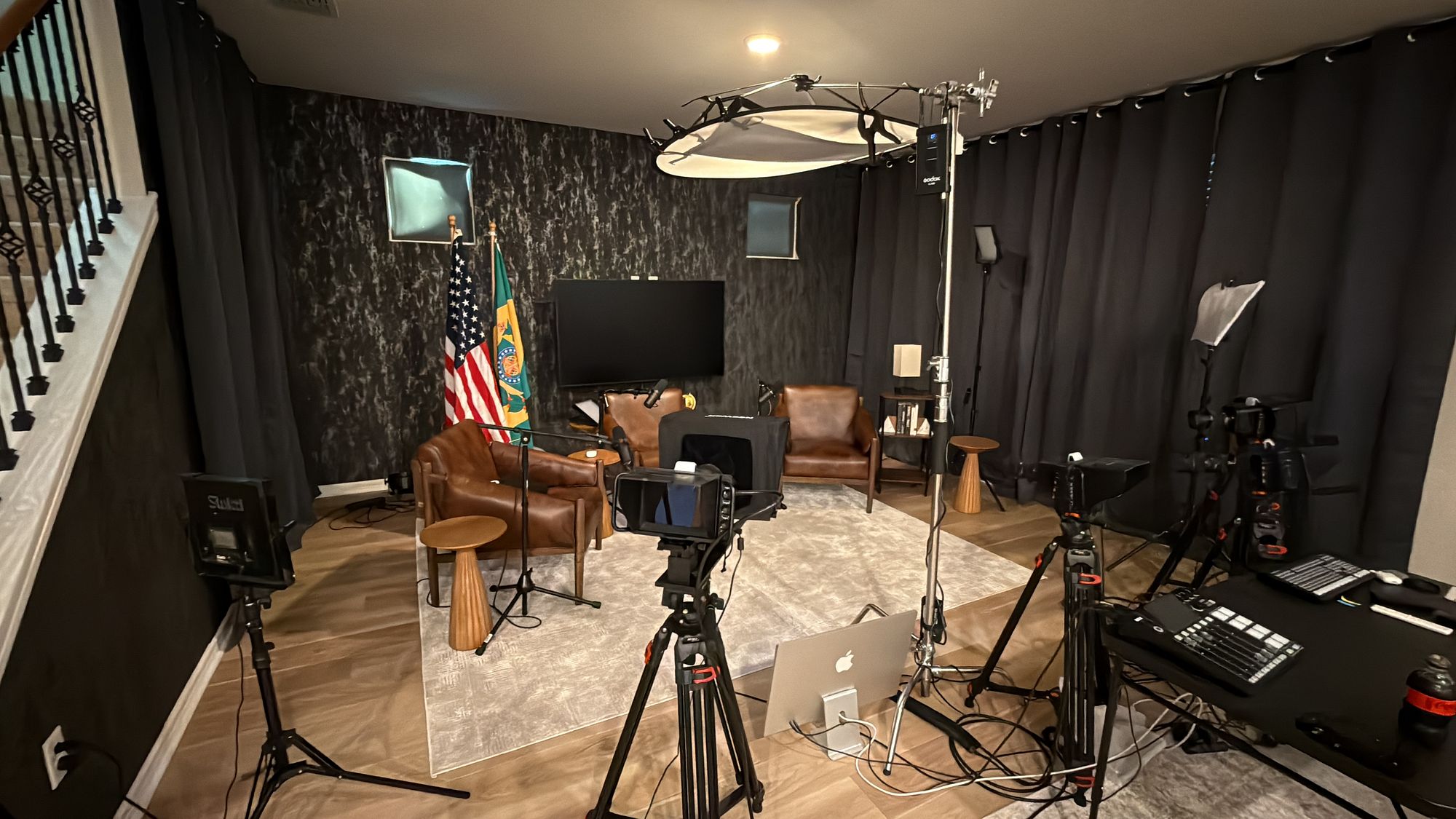 Recording studio with cameras, microphones, and an American flag
